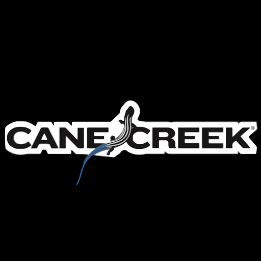 Cane Creek Cycling Components - Engineering Performance. Cane Creek Cycling Components logo with the company name in a distinctive font and a stylized graphic element resembling a creek or wave.